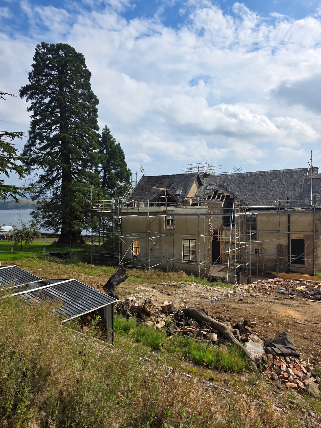 Roof and renovation works on a traditional building beside the water
