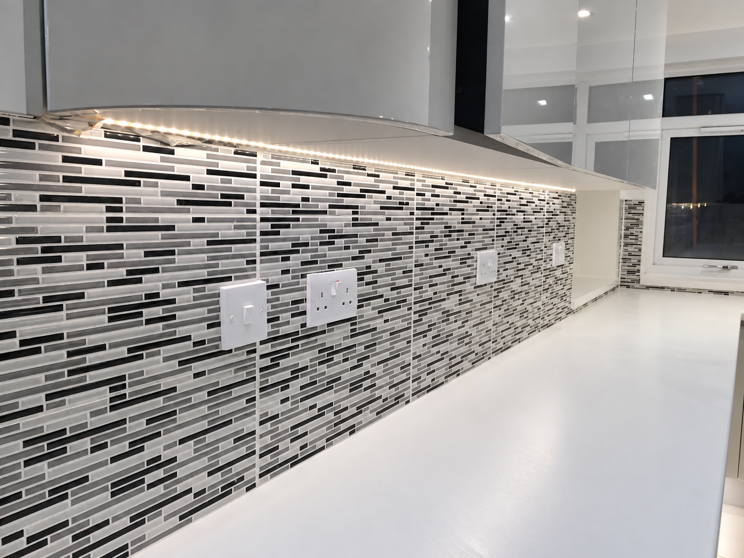 Mosaic tiling, fitted cabinetry and worktop detail